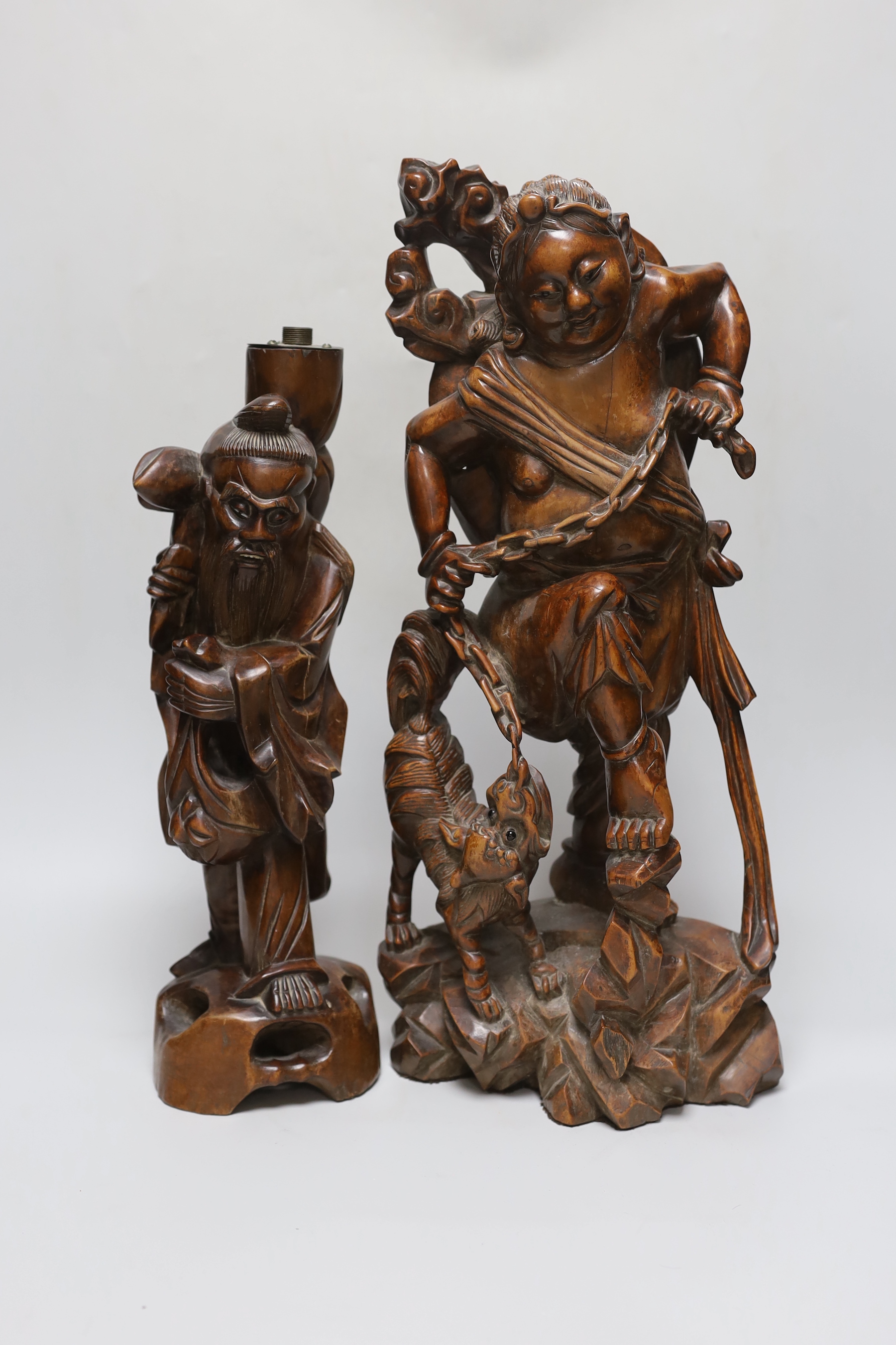 An early 20th century Chinese hardwood figure of Liu Hai, and a similar figure of Shou Lao (2), tallest 47cm